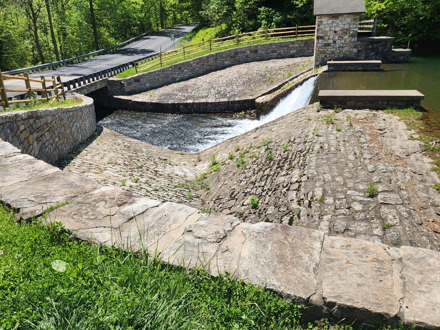 water flowing over the dam.