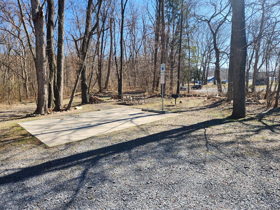 handicap parking spot and picnic table and grill.